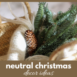 Image of some spruce twigs, a pine cone and some white knit fabric in a basket with a banner that reads neutral Christmas decor ideas.
