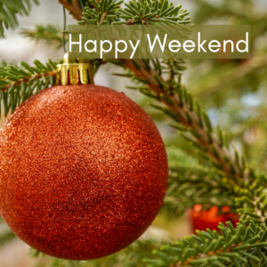 The image shows a red Christmas ornament hanging on a Christmas tree. The caption reads "Happy Weekend".
