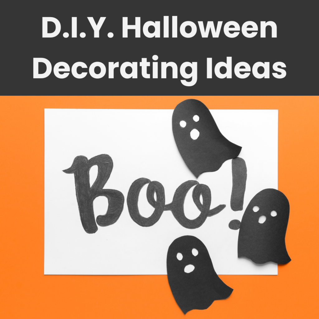 Image shows three cutout paper ghosts floating around a sign that reads Boo!